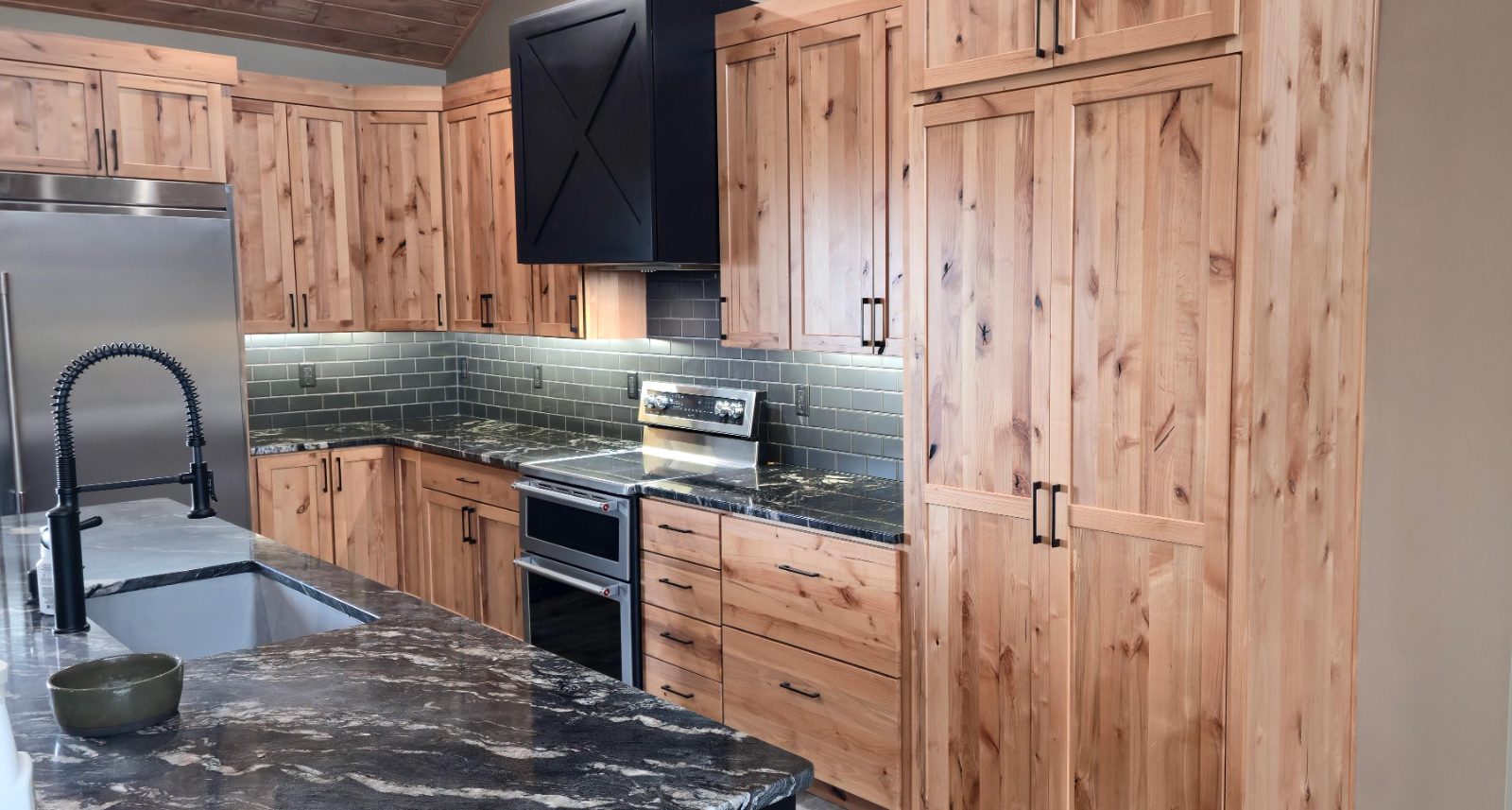 Custom knotty alder kitchen cabinetry and granite counters by Hahn Custom Homes