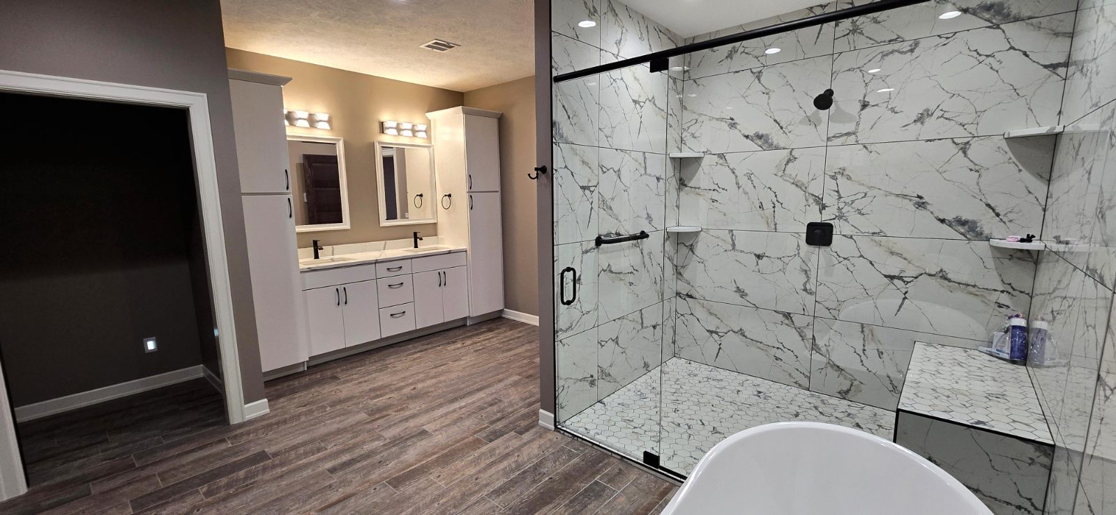 Primary bathroom with tile shower and double vanity in a Hahn custom home
